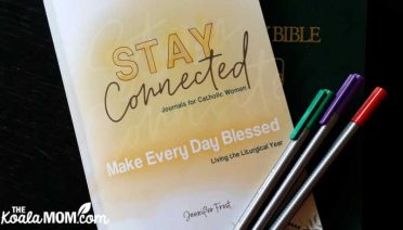Stay Connected Journals for Catholic Women: Make Every Day Blessed - Living the Liturgical Year by Jennifer Frost with a Bible and three colourful pens.