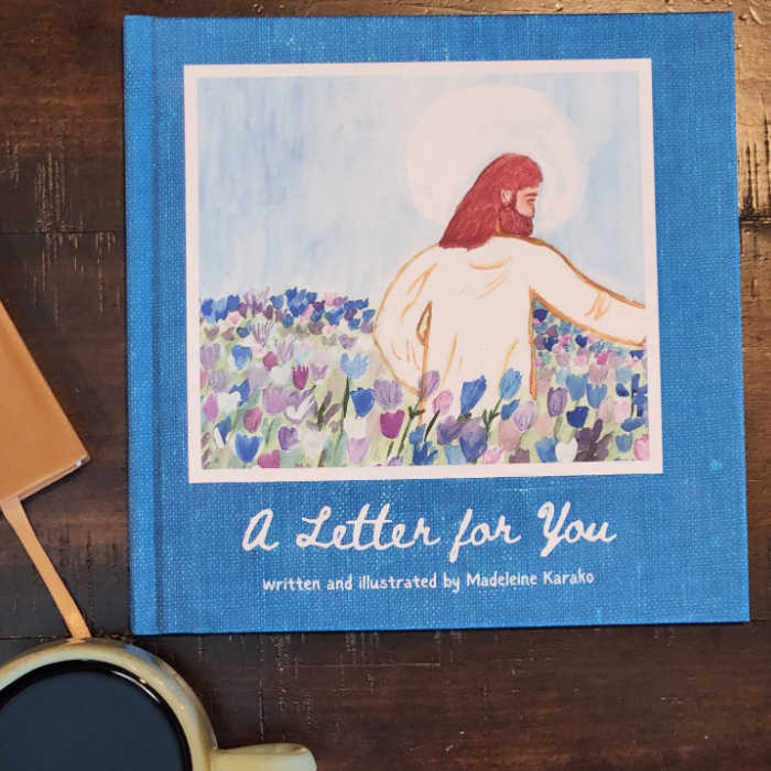 A Letter for You written and illustrated by Madeleine Karako, sitting on a table by a mug of coffee.