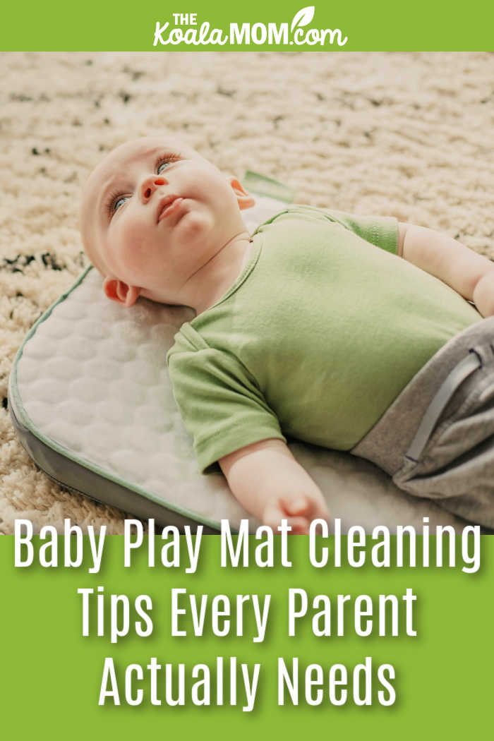 Baby Play Mat Cleaning Tips Every Parent Actually Needs. Photo of baby in a green onesie on a grey play mat by Alex Bodini on Unsplash.