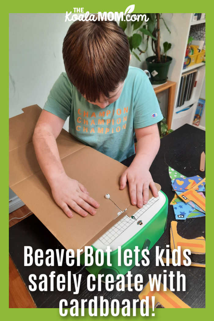BeaverBot C2 lets kids safely create with cardboard! Photo of boy using his green BeaverBoty cutter by Bonnie Way.