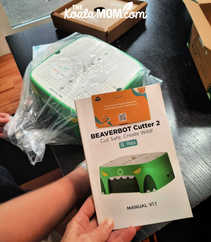 Unboxing the BeaverBot C2 and reading the instruction manual before we begin using it. Photo of cutter and manual by Bonnie Way.